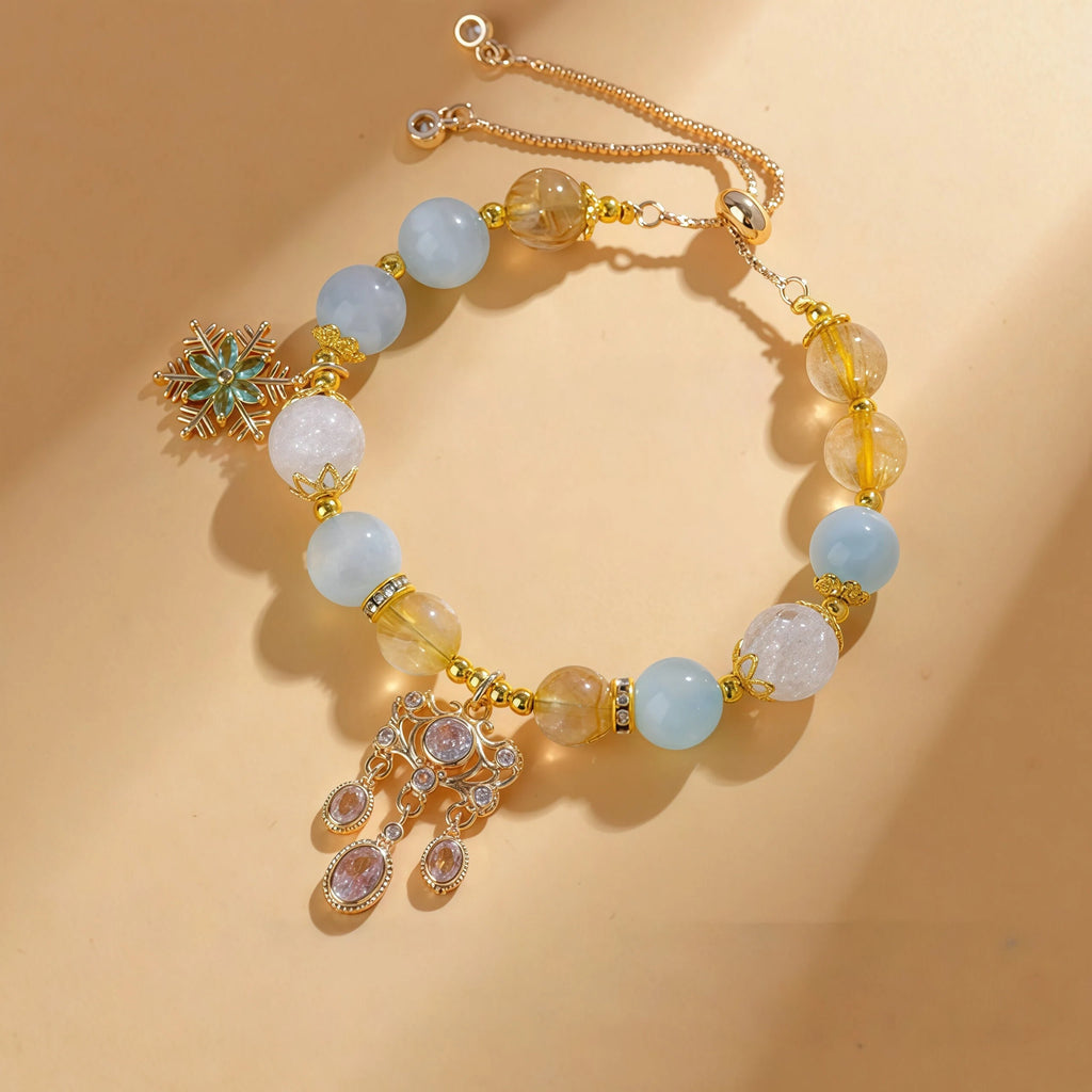 Libra Zodiac Bracelet featuring 10mm Flower Quartz, 9mm Aquamarine, and 8mm Golden Rutilated Quartz. Gold adjustable healing jewelry for balance with an elegant Chandelier charm - Kosmos Zen