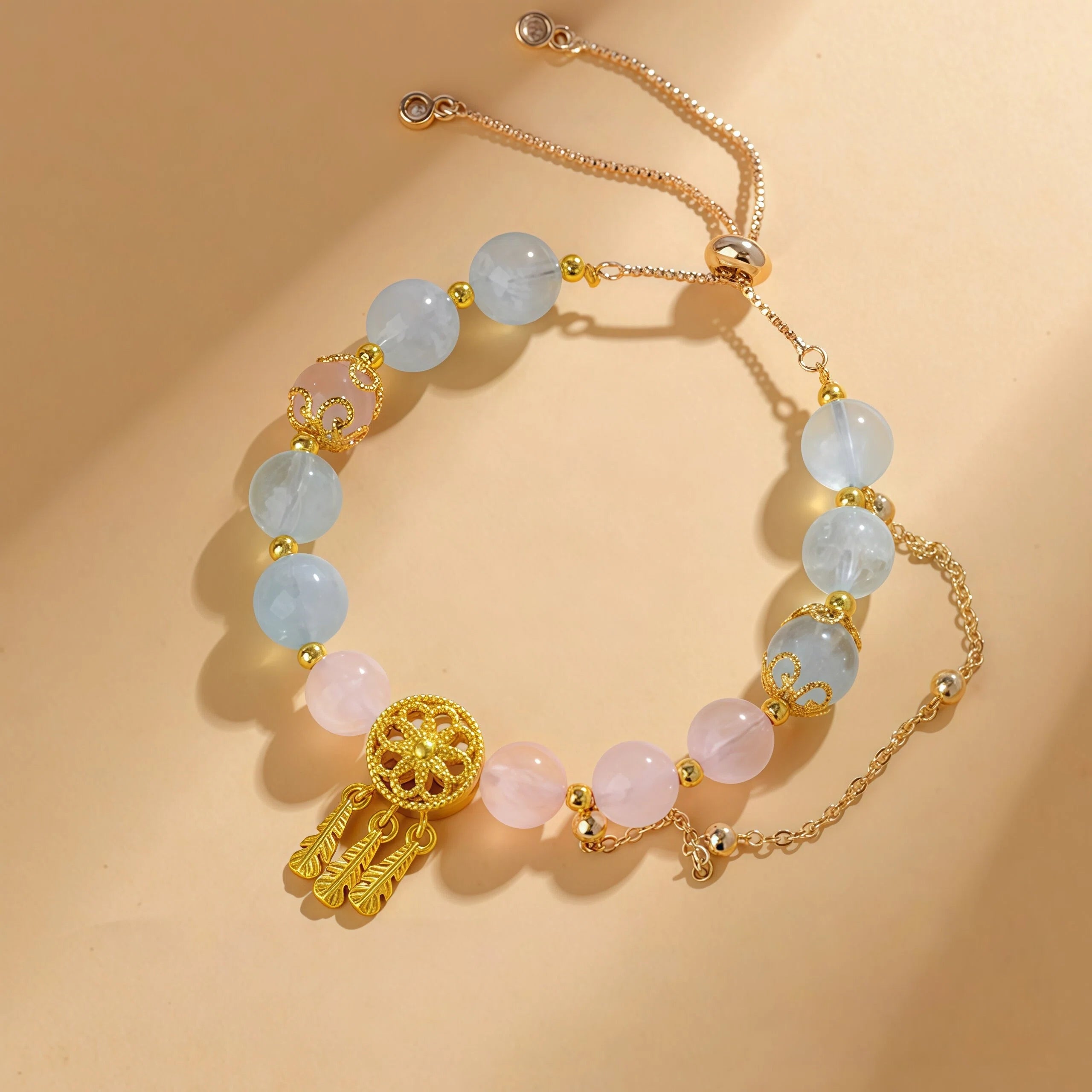 Pisces Zodiac Bracelet featuring 9mm Rose Quartz and Aquamarine beads. Gold healing jewelry for emotional flow with a dangling Dreamcatcher charm - Kosmos Zen