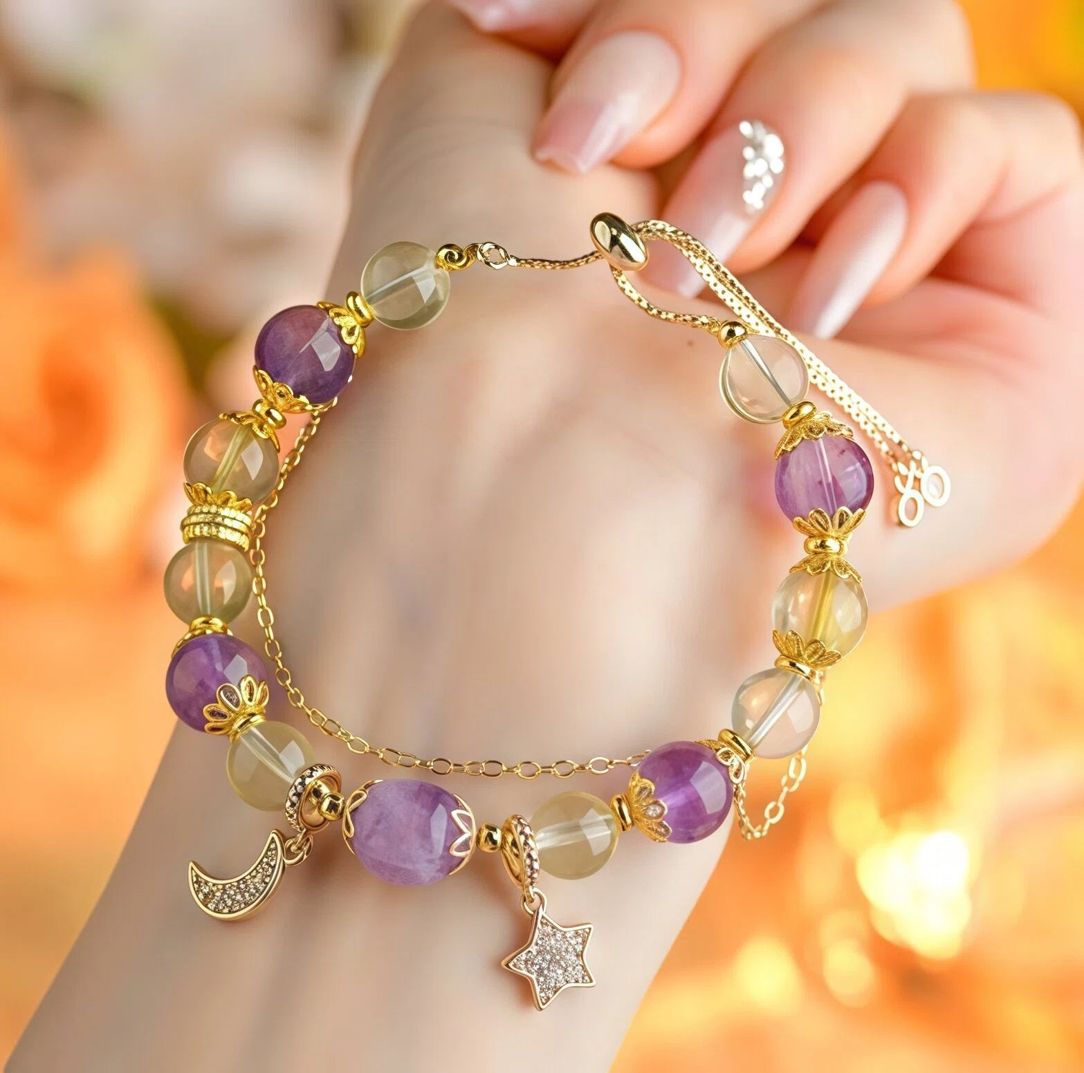 Hand holding Taurus Zodiac Bracelet featuring 9mm Golden Rutilated Quartz and 10mm Amethyst. Close-up detail of 8mm Citrine beads and Moon Star charms for wealth and abundance - Kosmos Zen